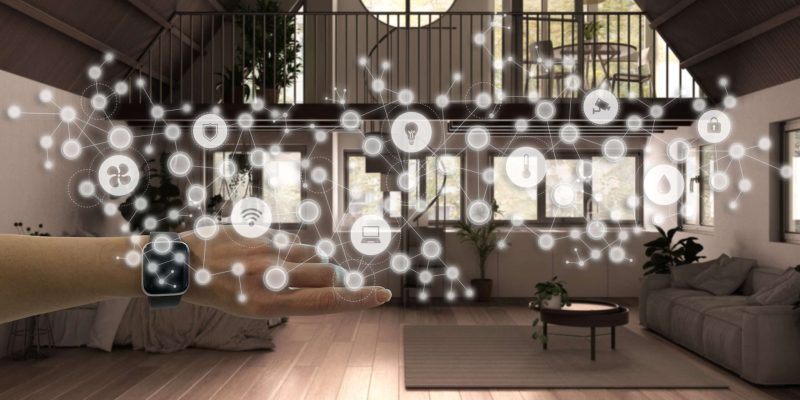 Woman wearing a smart watch, arm, wrist, geometric background with connected line and dots showing internet of things system, home automation concept over country studio apartment Avocat Domotique