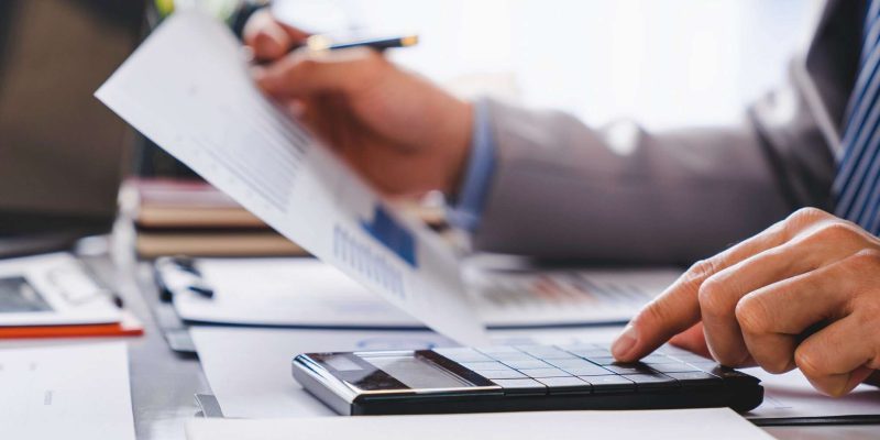 Business Financing, businessman doing finances and calculating about the cost to real estate investment and in other, tax system. Accounting Banking Concept avocat fiscalité numérique