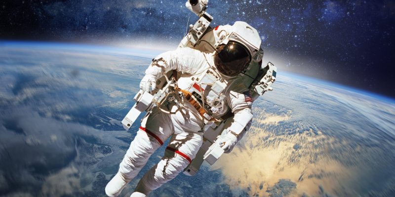 Astronaut in outer space with planet earth as backdrop. Elements Astronaut in outer space with planet earth as backdrop. Elements of this image furnished by NASA.